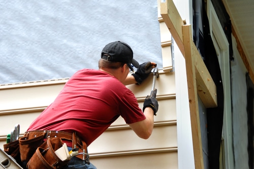 Young,Homeowner,Installs,Siding,To,His,Home.,He,Is,Holding