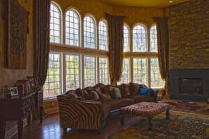 A grand living room with floor to ceiling winodws