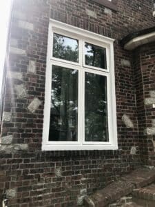 Picture of beautiful awning windows installed on a brick house.